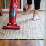 Aspirateur rouge utilise sur un tapis